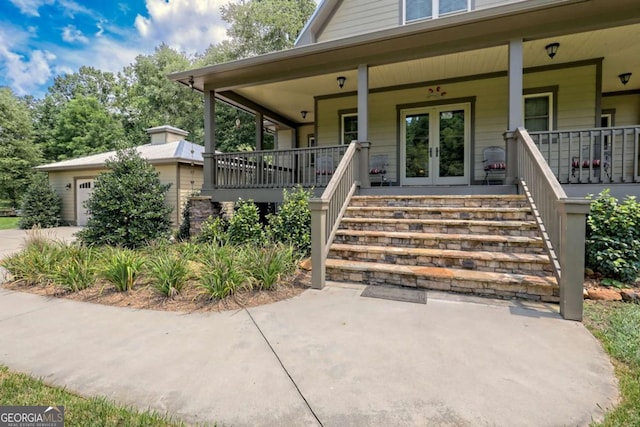 153 Falls Creek Dr, Hiawassee, GA 30546 - property entrance featuring covered porch, french doors, driveway, and a garage