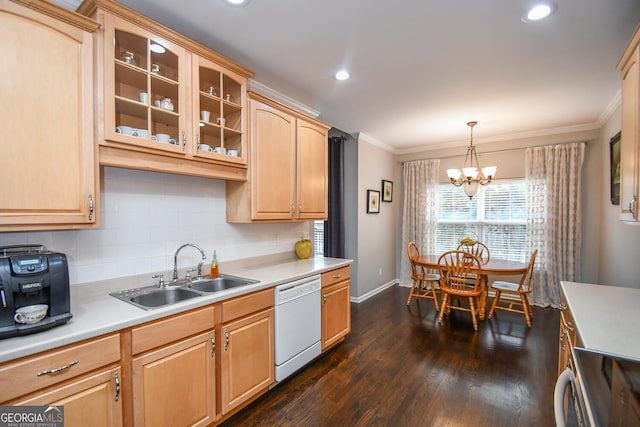 kitchen with white dishwasher, a sink, light countertops, glass insert cabinets, and pendant lighting