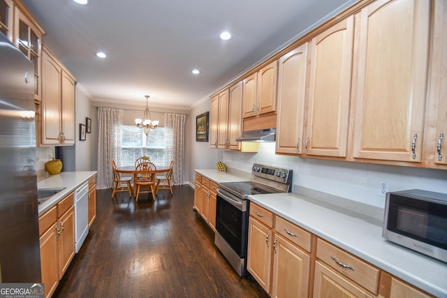 kitchen with dark wood-type flooring, hanging light fixtures, stainless steel appliances, light countertops, and under cabinet range hood