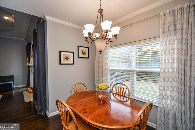 dining space with dark wood-style floors, a notable chandelier, crown molding, and baseboards