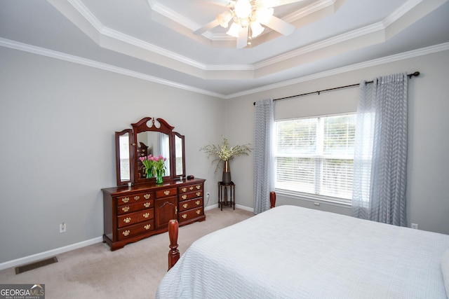 bedroom featuring light carpet, baseboards, visible vents, a raised ceiling, and crown molding