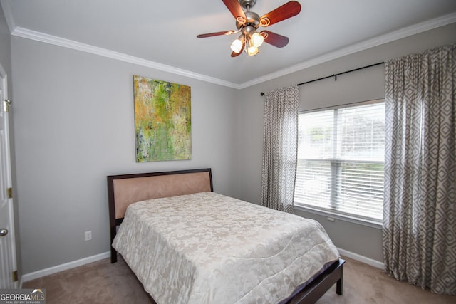 carpeted bedroom featuring crown molding, baseboards, and ceiling fan