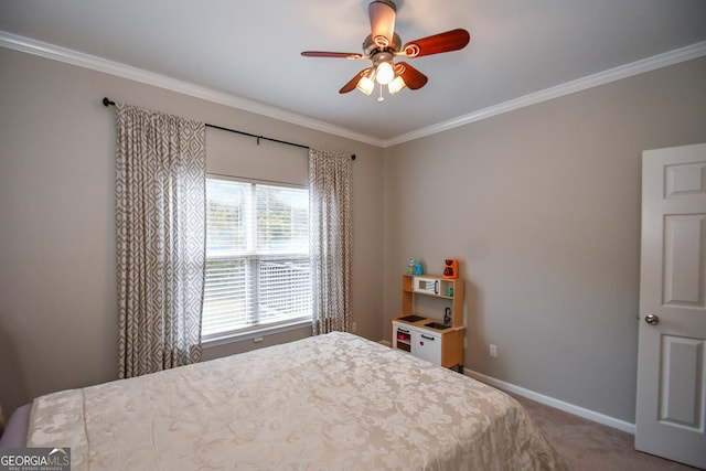 carpeted bedroom featuring ornamental molding, ceiling fan, and baseboards