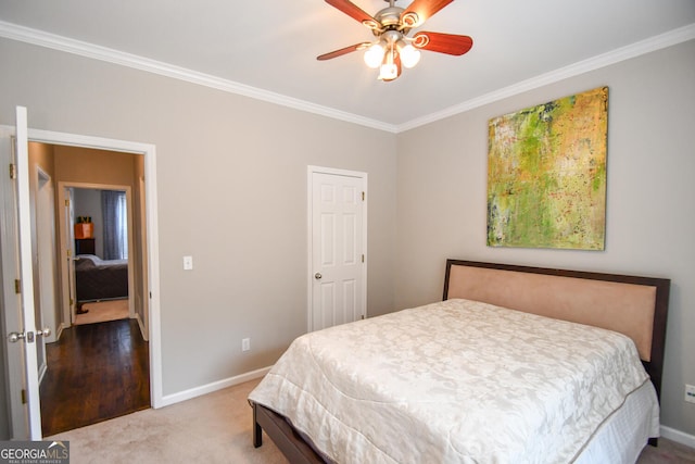 carpeted bedroom with baseboards, ornamental molding, and ceiling fan