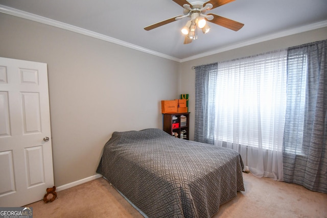 bedroom with ornamental molding, light colored carpet, ceiling fan, and baseboards