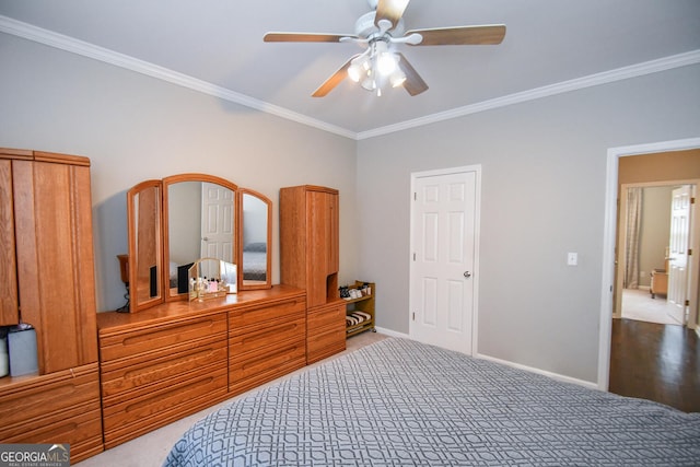 bedroom featuring ornamental molding, carpet flooring, a ceiling fan, and baseboards