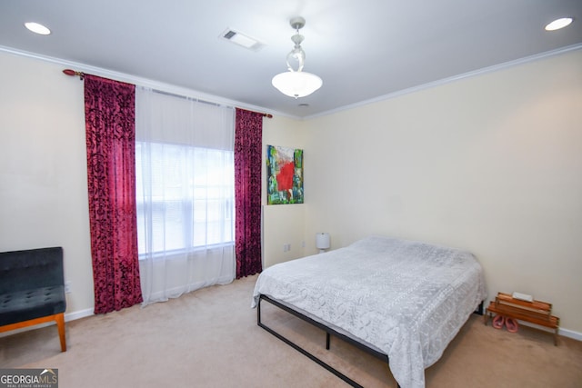 bedroom featuring visible vents, crown molding, and light colored carpet