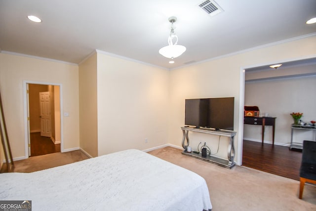 bedroom featuring carpet floors, baseboards, visible vents, and ornamental molding