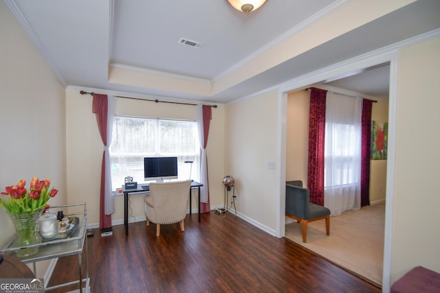 home office featuring a wealth of natural light, visible vents, a raised ceiling, and crown molding