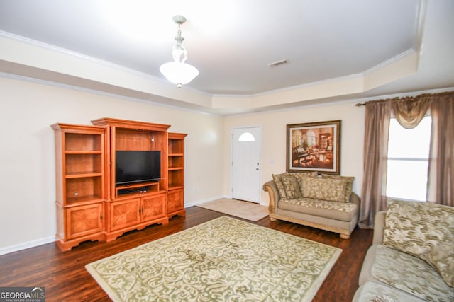 living room featuring visible vents, baseboards, dark wood-style floors, a tray ceiling, and crown molding