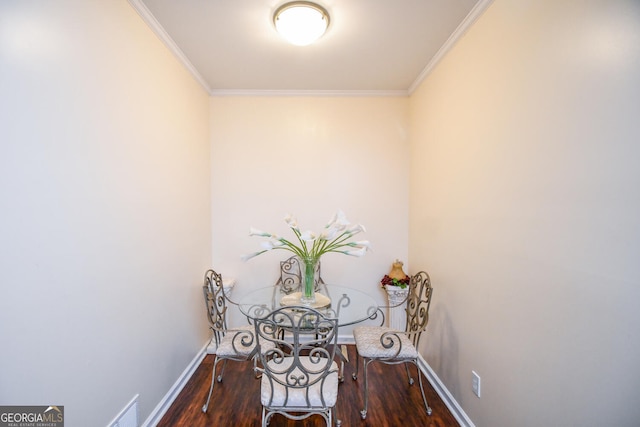 unfurnished dining area with baseboards, ornamental molding, and dark wood-type flooring