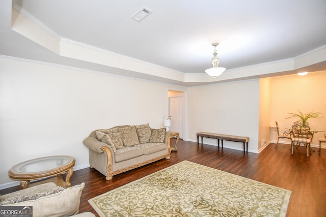 living room featuring crown molding, a raised ceiling, visible vents, and dark wood finished floors