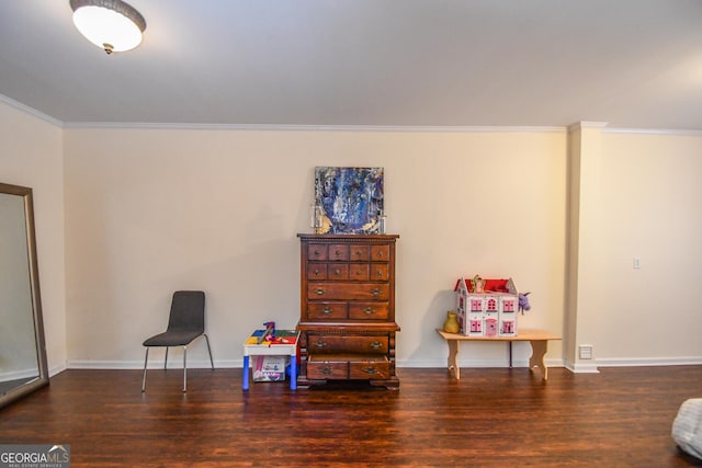 sitting room with crown molding, dark wood finished floors, and baseboards