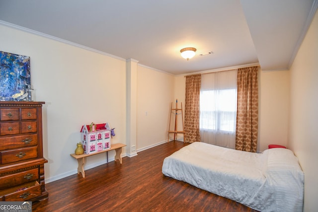 bedroom with dark wood-type flooring, visible vents, crown molding, and baseboards