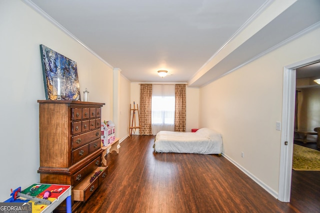 bedroom with baseboards, ornamental molding, and dark wood-style flooring