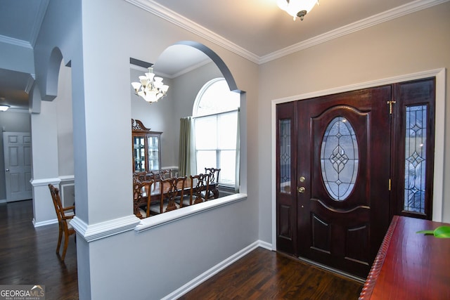 foyer entrance featuring arched walkways, dark wood-style flooring, crown molding, and baseboards