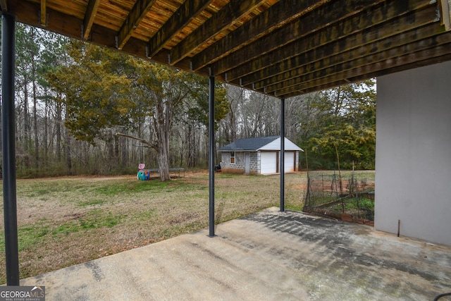 view of patio featuring an outbuilding and a garage