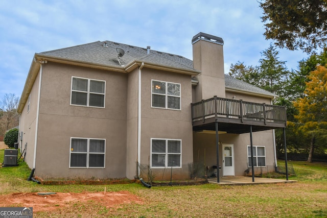 back of property with a patio, a yard, a chimney, stucco siding, and cooling unit