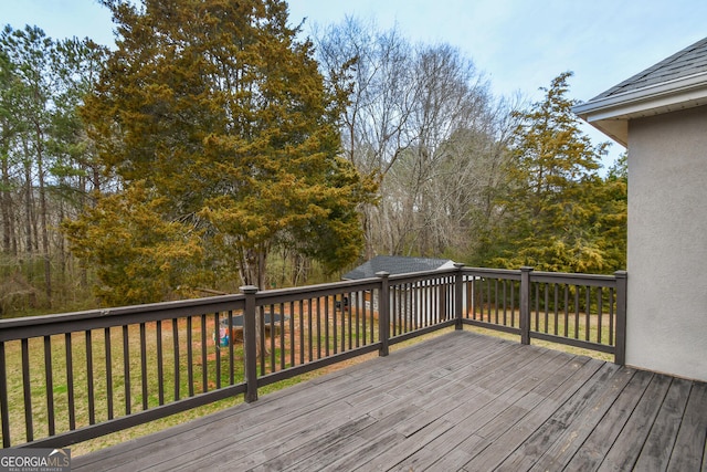 wooden terrace with a lawn