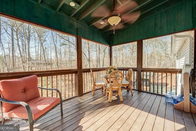 sunroom featuring plenty of natural light, ceiling fan, and lofted ceiling