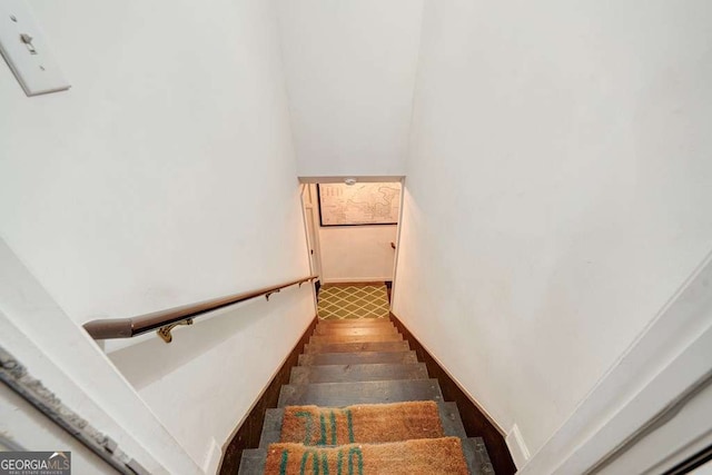 stairway featuring wood finished floors