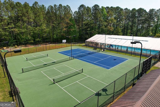 view of sport court featuring fence