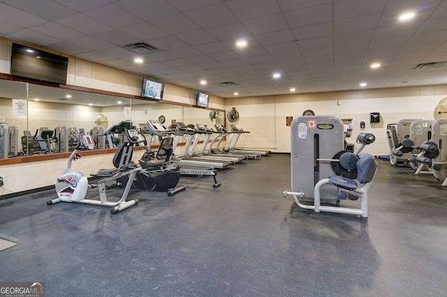 workout area featuring a paneled ceiling and visible vents