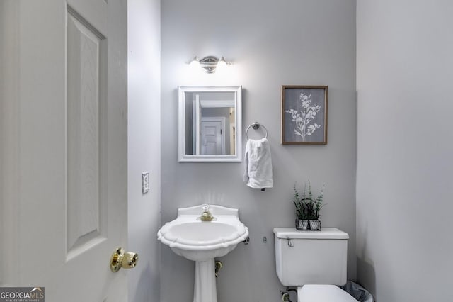 half bath featuring a sink and toilet