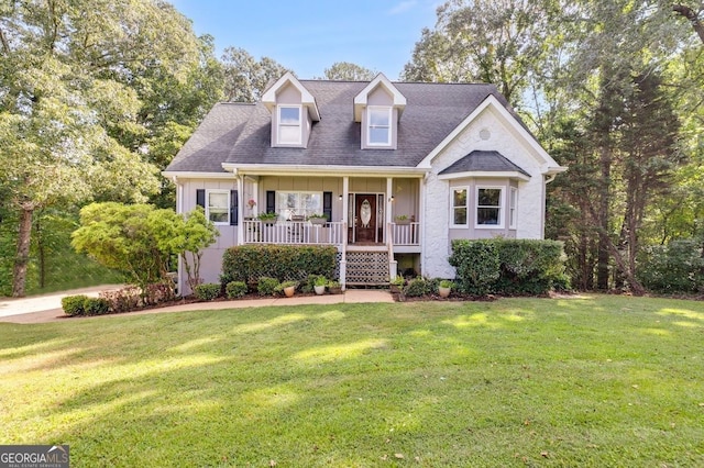 cape cod home featuring a front lawn, covered porch, and board and batten siding