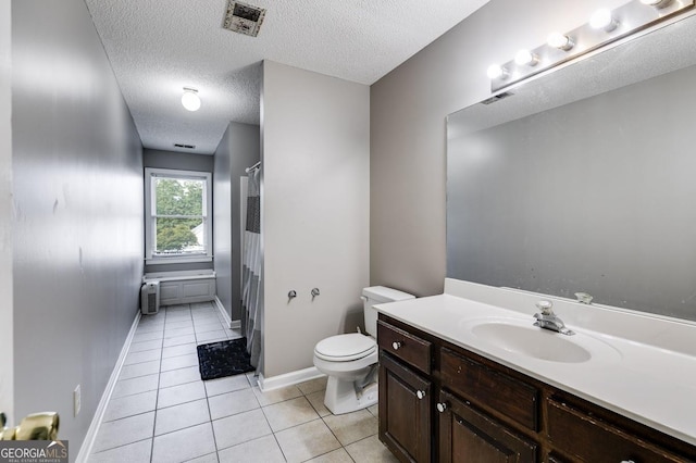 bathroom with vanity, visible vents, toilet, tile patterned floors, and radiator