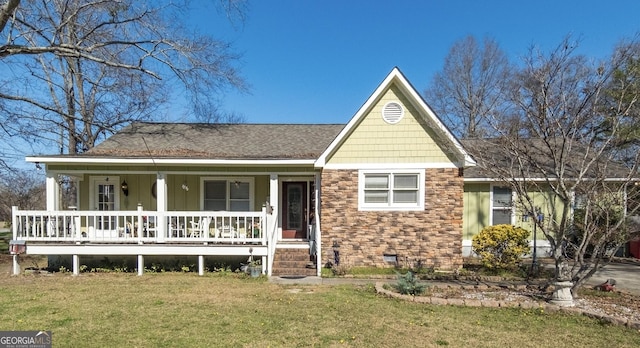 view of front facade featuring a porch, crawl space, stone siding, and a front lawn