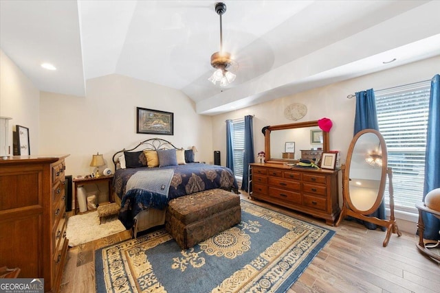 bedroom featuring vaulted ceiling, recessed lighting, and light wood-style floors