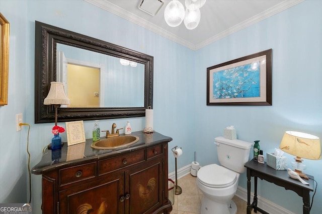 bathroom with vanity, crown molding, baseboards, toilet, and tile patterned flooring