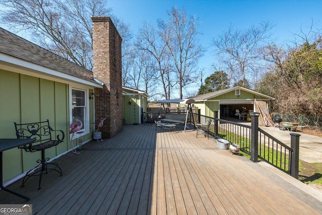 deck featuring an outbuilding and fence