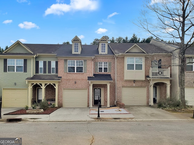 view of property featuring a garage, concrete driveway, and brick siding