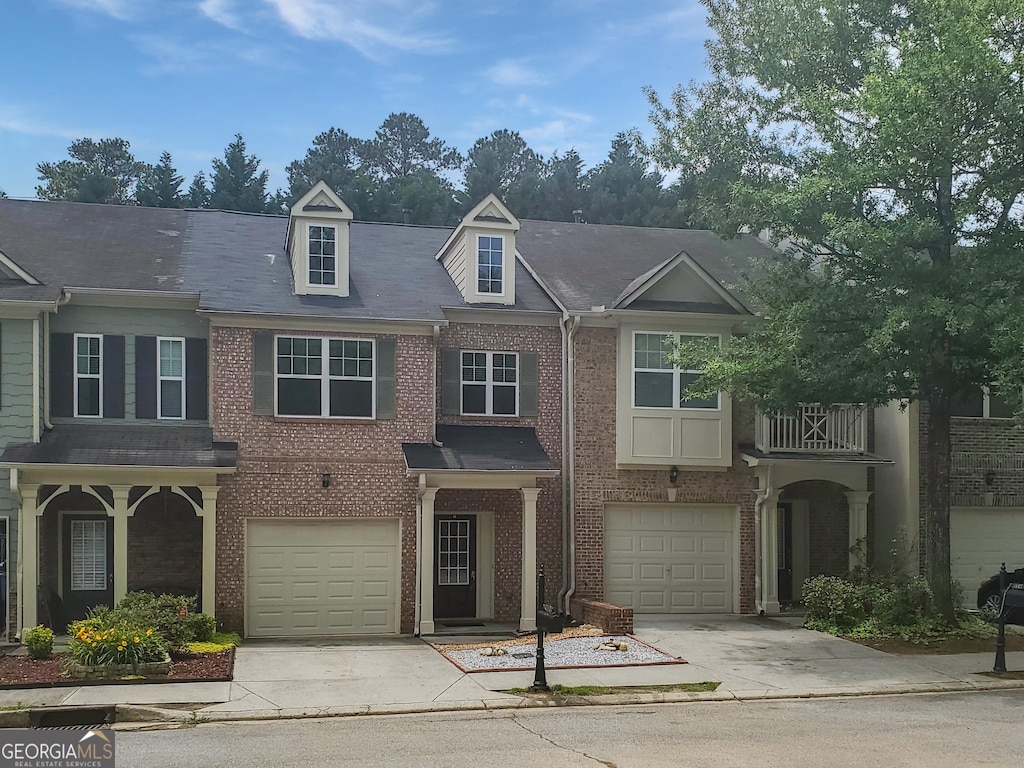1649 Southgate Mill Dr NW, Duluth, GA 30096 - townhome / multi-family property with driveway, an attached garage, and brick siding