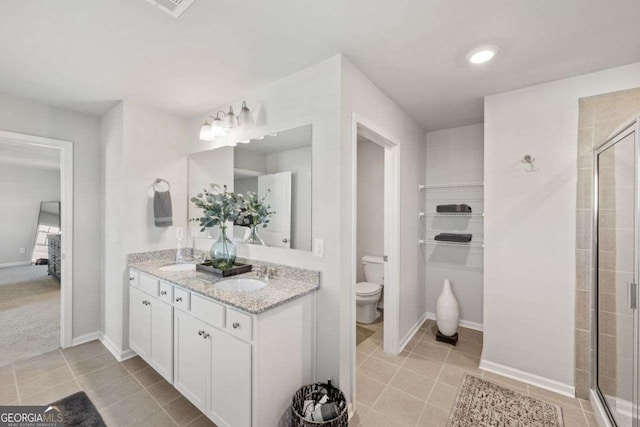 6713 Moondancer Ct, Flowery Branch, GA 30542 - ensuite bathroom featuring double vanity, tile patterned flooring, and a tile shower