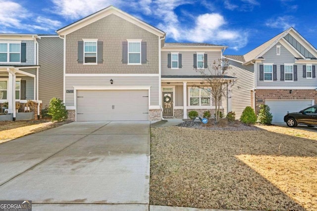 view of front of house featuring an attached garage, driveway, and covered porch