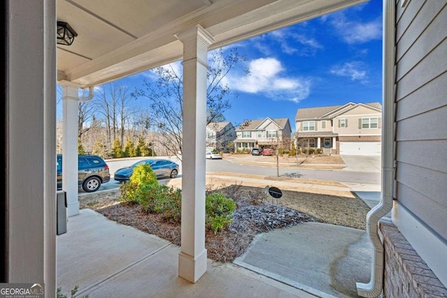 view of patio featuring a porch and a residential view