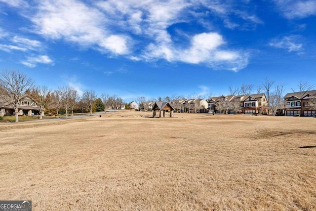 6713 Moondancer Ct, Flowery Branch, GA 30542 - view of green lawn with a residential view