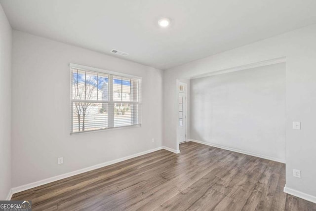 6713 Moondancer Ct, Flowery Branch, GA 30542 - spare room featuring wood finished floors and baseboards