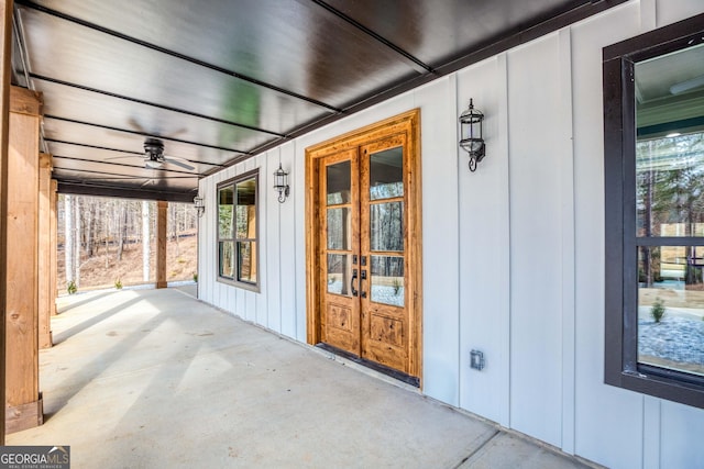 entrance to property with a porch, french doors, and board and batten siding