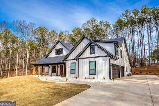 modern farmhouse style home featuring concrete driveway, board and batten siding, a shingled roof, and a garage