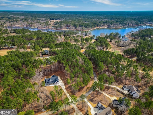 bird's eye view with a forest view and a water view