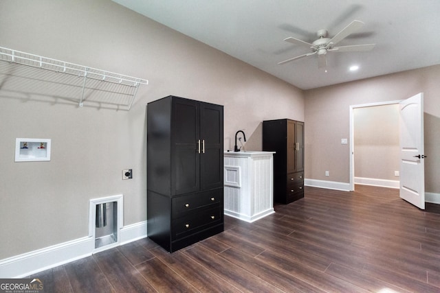 interior space featuring baseboards, dark wood-style flooring, light countertops, and dark cabinets