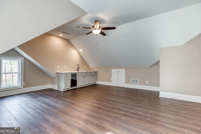 bonus room featuring vaulted ceiling, visible vents, and dark wood-style floors