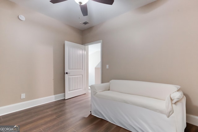 living area with baseboards, ceiling fan, visible vents, and dark wood-type flooring