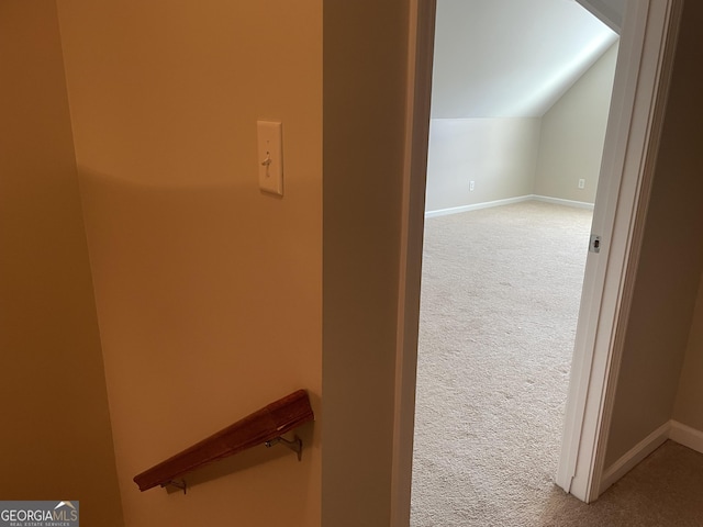 additional living space featuring carpet flooring, baseboards, and vaulted ceiling