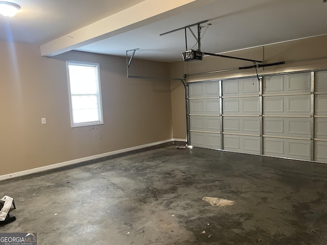 garage with baseboards and a garage door opener