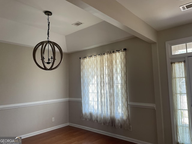 unfurnished dining area with baseboards, an inviting chandelier, visible vents, and dark wood-style flooring